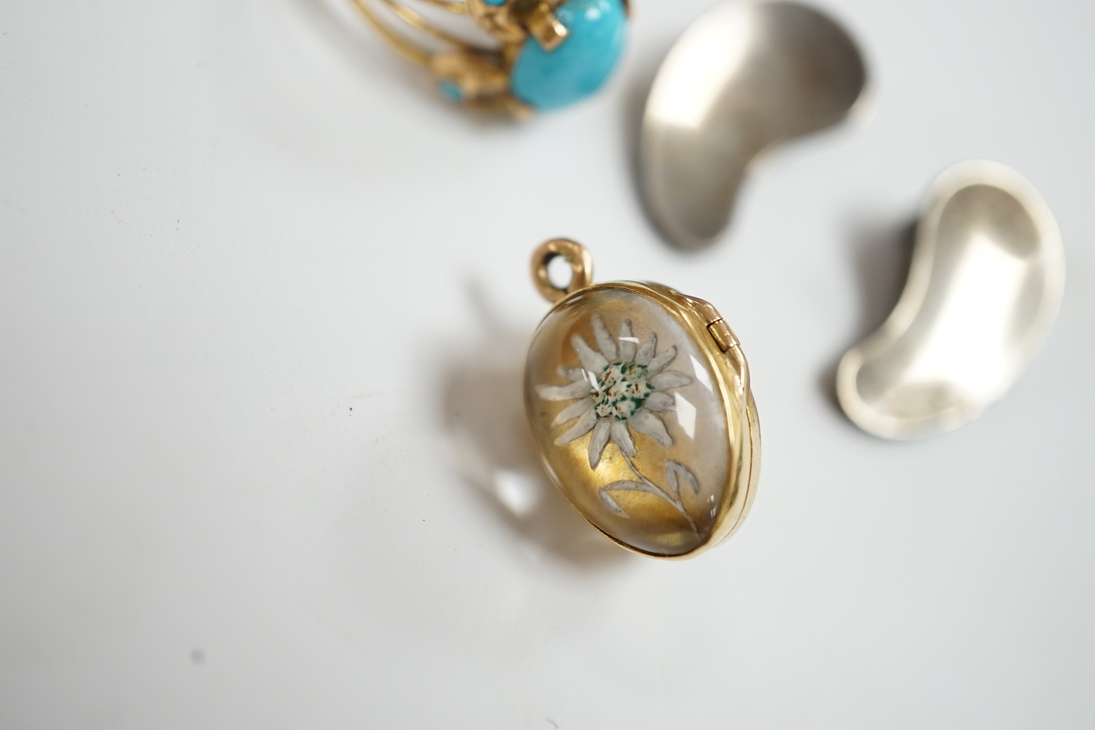 A Middle Eastern yellow metal and turquoise cluster set ring, size P/Q, together with a yellow metal and Essex crystal style egg shaped pendant, depicting a flower and a pair of Georg Jensen sterling ear clips, design no